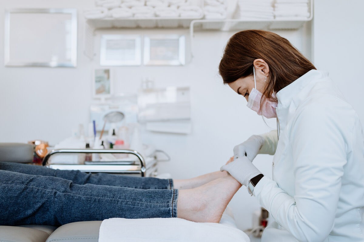 Podiatrist examning feet | the society of tissue viability