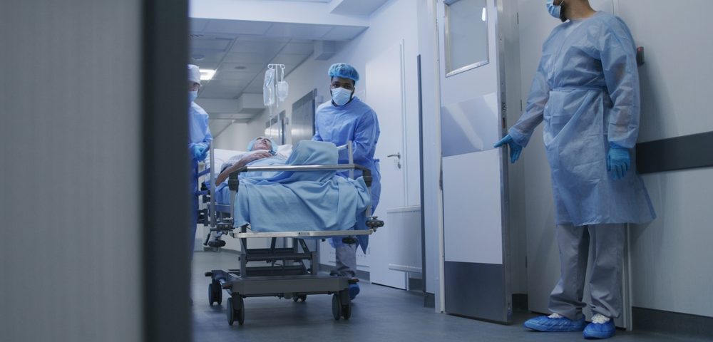 Overcrowded emergency department with patients on trolleys